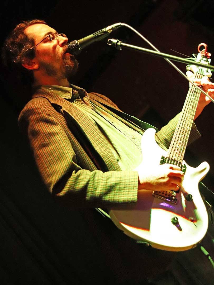 Cade Howard singing and playing guitar