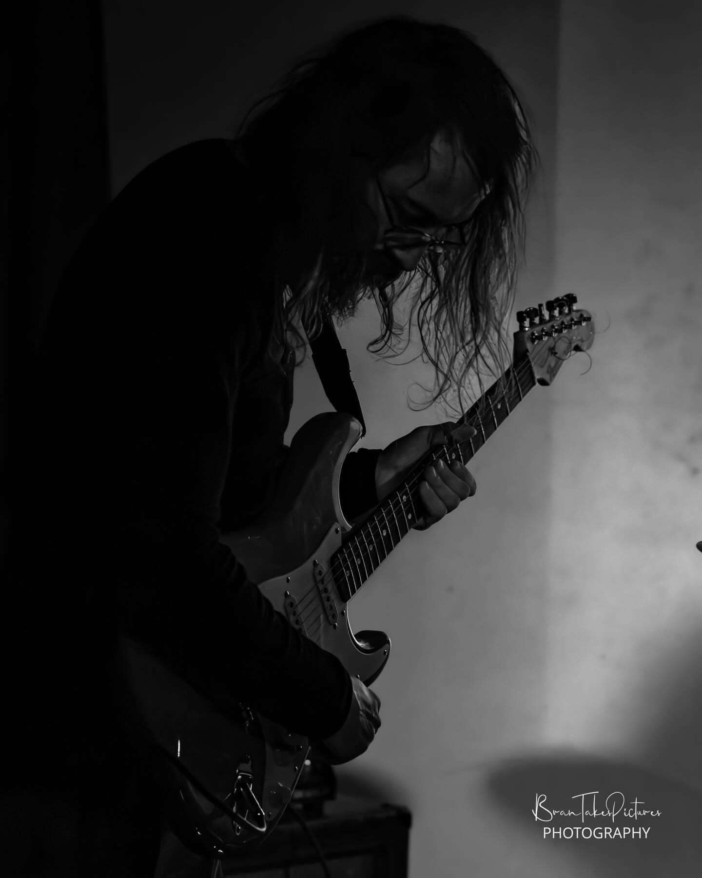 Silhouetted guitar performance in black and white